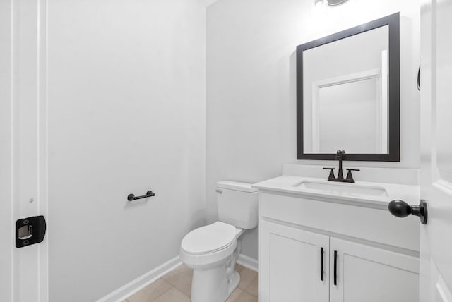 bathroom with vanity, toilet, and tile patterned floors