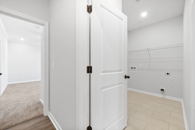 washroom with washer hookup, light hardwood / wood-style floors, and electric dryer hookup