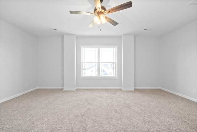 empty room featuring light colored carpet and ceiling fan