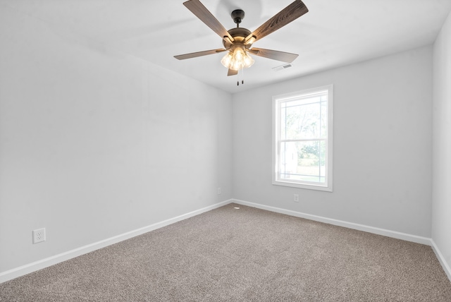 carpeted empty room featuring ceiling fan