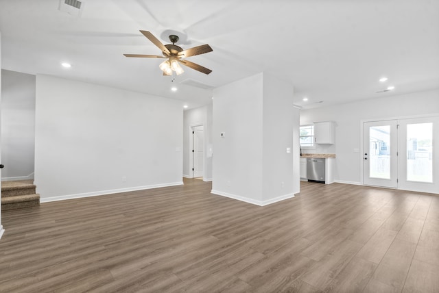 unfurnished living room with dark hardwood / wood-style floors and ceiling fan