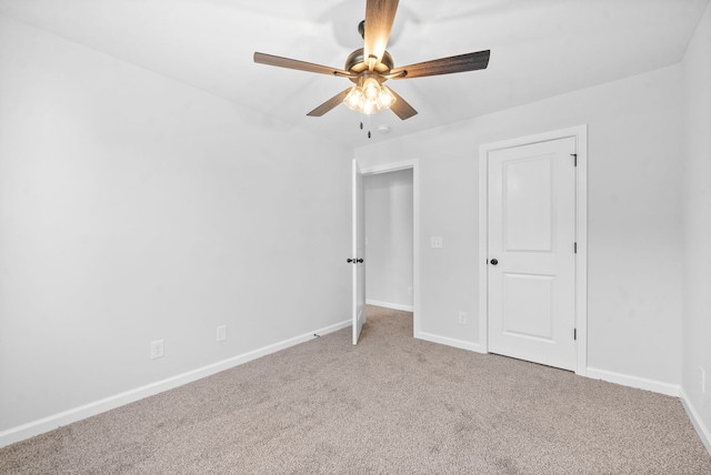 unfurnished bedroom with ceiling fan and carpet