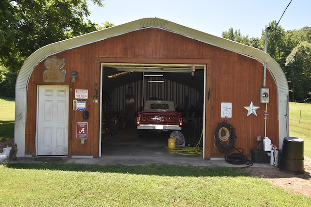 view of outbuilding featuring a garage and a lawn