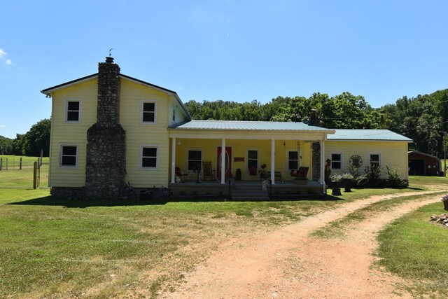 view of front of home with a front yard and covered porch