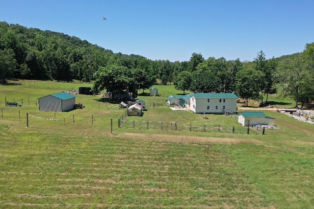 surrounding community with a rural view and a lawn