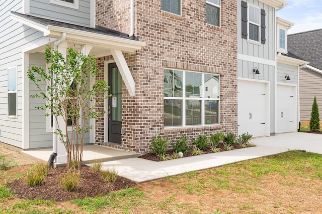 doorway to property with a garage