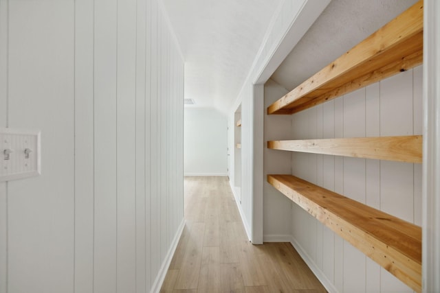 hallway with light wood-style floors and baseboards