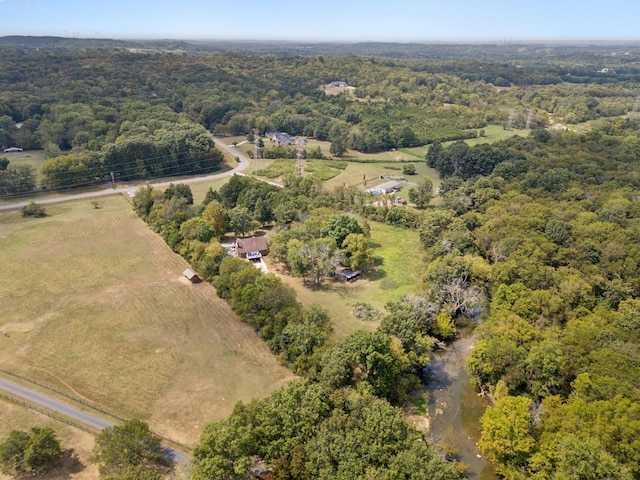 birds eye view of property featuring a view of trees