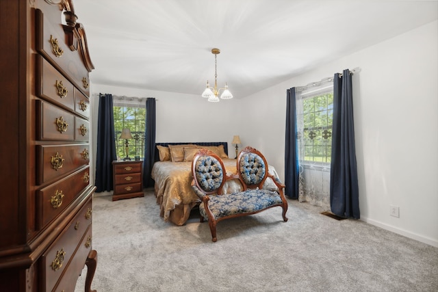 bedroom with light carpet, multiple windows, and a notable chandelier