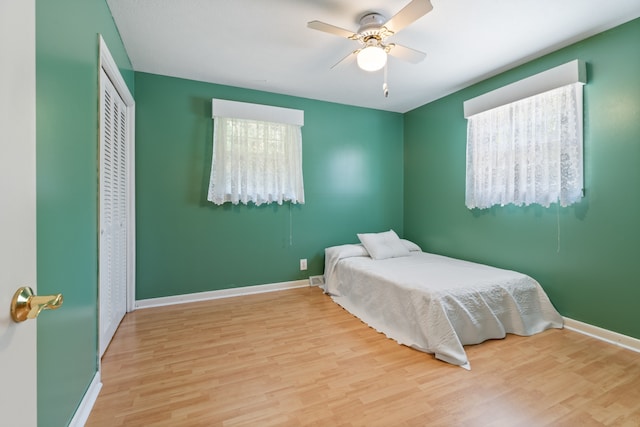 bedroom with light wood-type flooring and ceiling fan