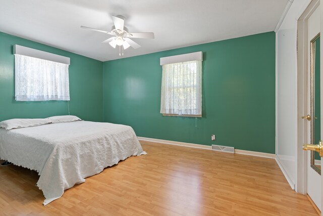 bedroom with ceiling fan and light hardwood / wood-style floors