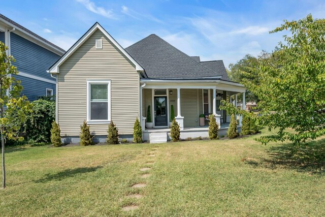 view of front of property with a front yard and a porch