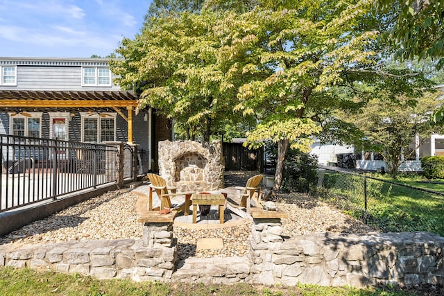 view of yard featuring ceiling fan, a patio, and an outdoor fire pit