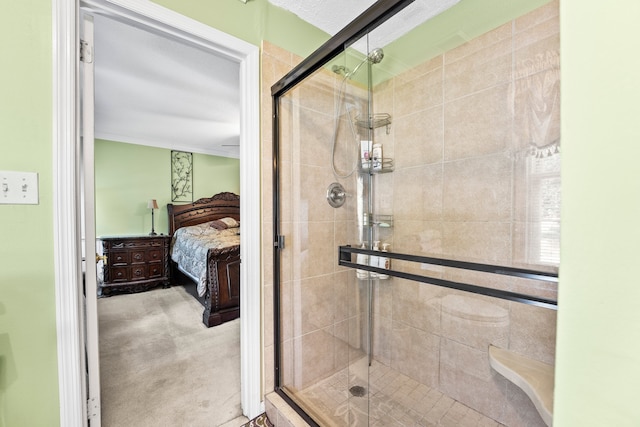 bathroom featuring ornamental molding and an enclosed shower