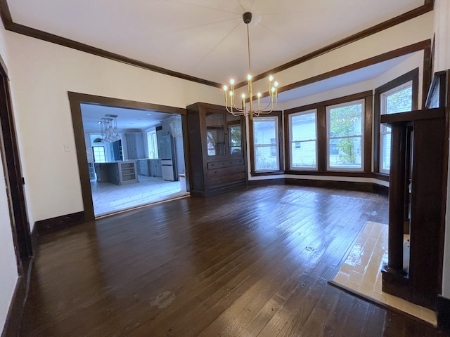 unfurnished dining area featuring crown molding, dark hardwood / wood-style flooring, and a chandelier