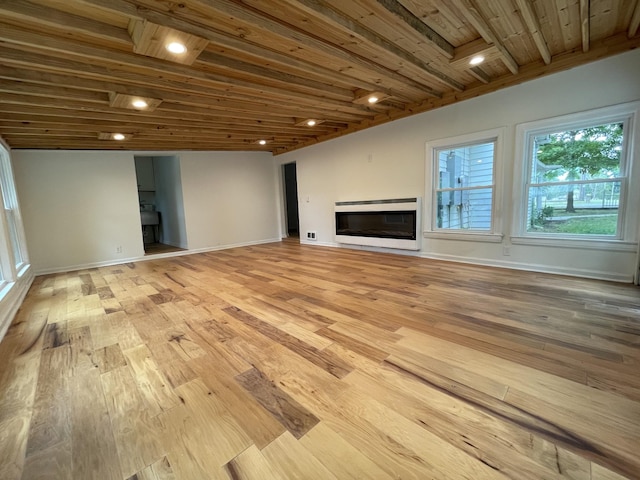 401 College St, Petersburg, TN 37144 - unfurnished living room with recessed lighting, a glass covered fireplace, wood ceiling, light wood-type flooring, and baseboards