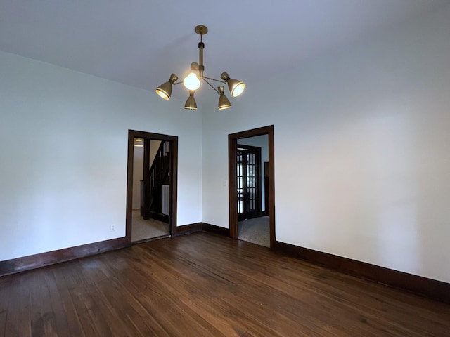 401 College St, Petersburg, TN 37144 - unfurnished room featuring a notable chandelier, dark wood-type flooring, and baseboards