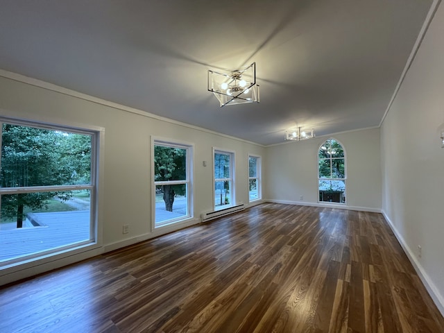 unfurnished room with baseboard heating, dark hardwood / wood-style flooring, plenty of natural light, and a chandelier