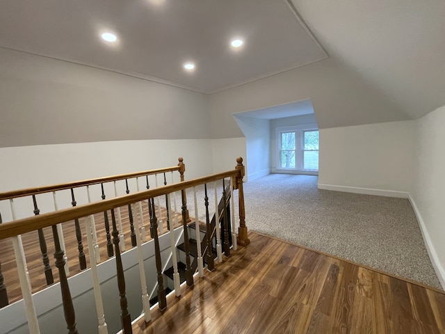 bonus room with vaulted ceiling and hardwood / wood-style flooring