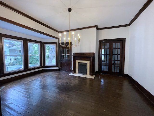 unfurnished living room with ornamental molding, dark hardwood / wood-style flooring, and a notable chandelier