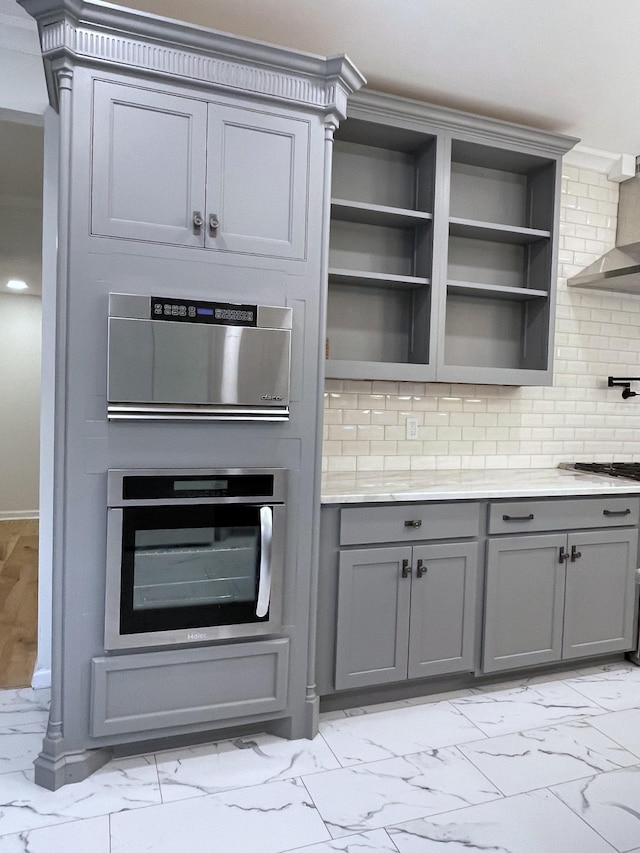 401 College St, Petersburg, TN 37144 - kitchen with marble finish floor, light countertops, backsplash, gray cabinetry, and oven