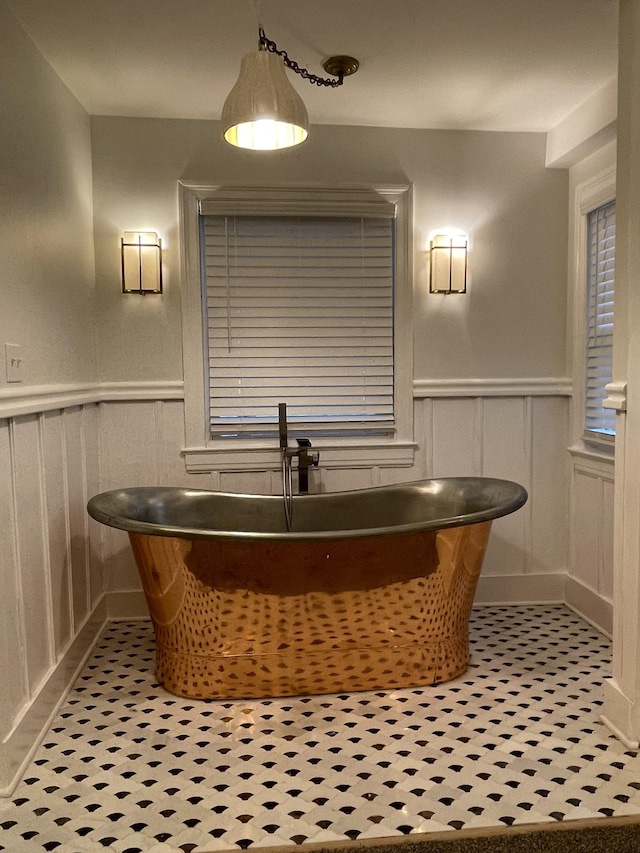 401 College St, Petersburg, TN 37144 - full bathroom with a freestanding tub and wainscoting