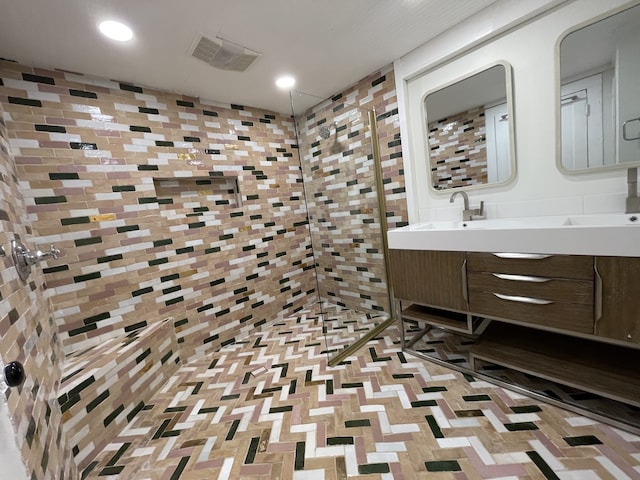 bathroom with vanity and tiled shower