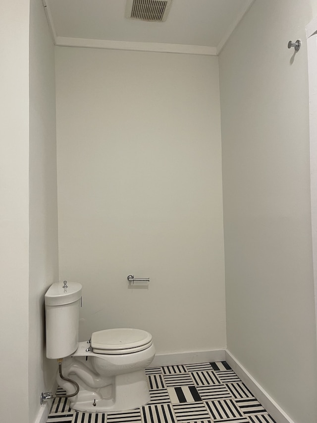 bathroom featuring toilet and ornamental molding