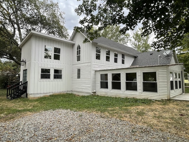 rear view of property featuring a yard