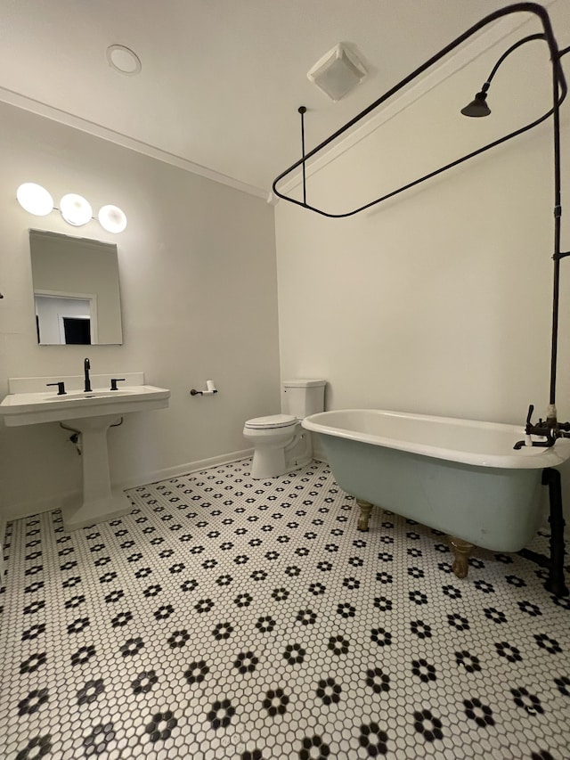 bathroom featuring a tub, toilet, and ornamental molding