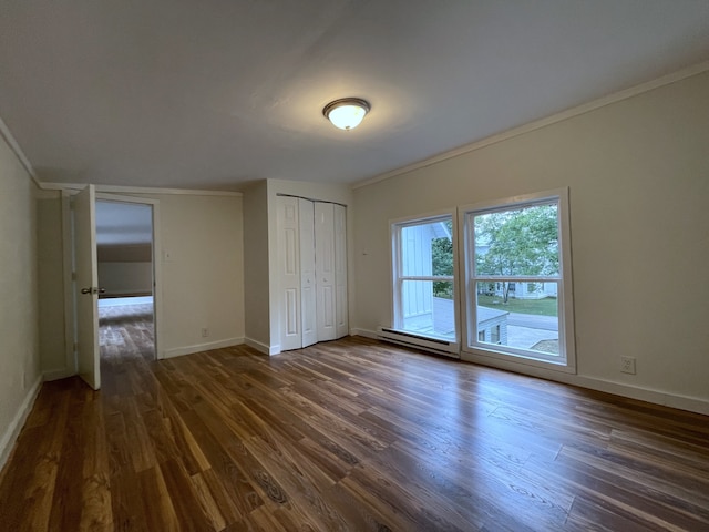 unfurnished bedroom featuring crown molding, dark hardwood / wood-style floors, a baseboard radiator, and access to exterior