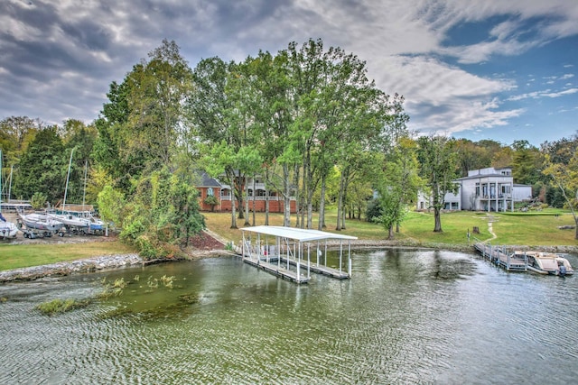 view of dock with a water view and a lawn