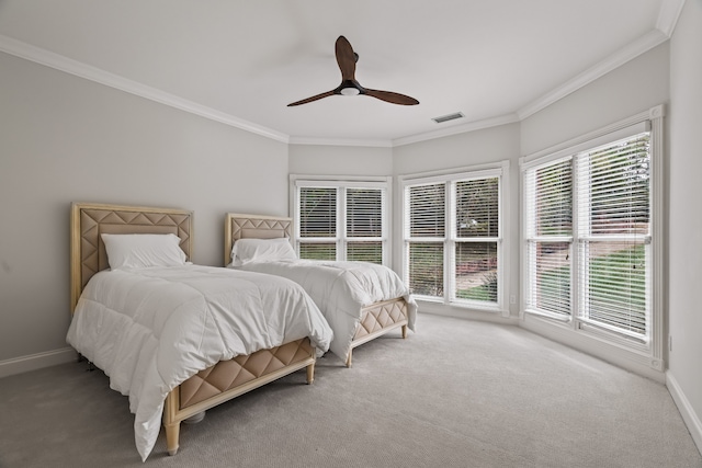 bedroom featuring multiple windows, ceiling fan, carpet, and crown molding