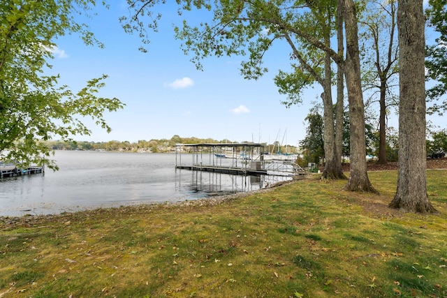 dock area with a yard and a water view