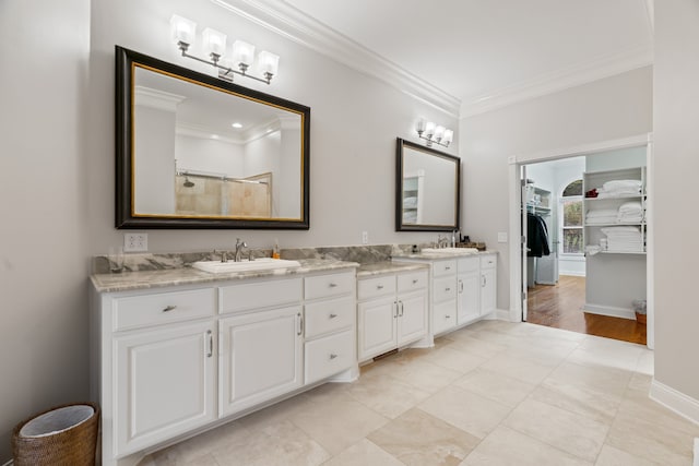 bathroom featuring walk in shower, ornamental molding, and vanity