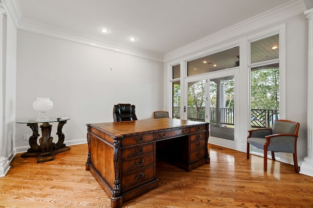 office area with light wood-type flooring and crown molding