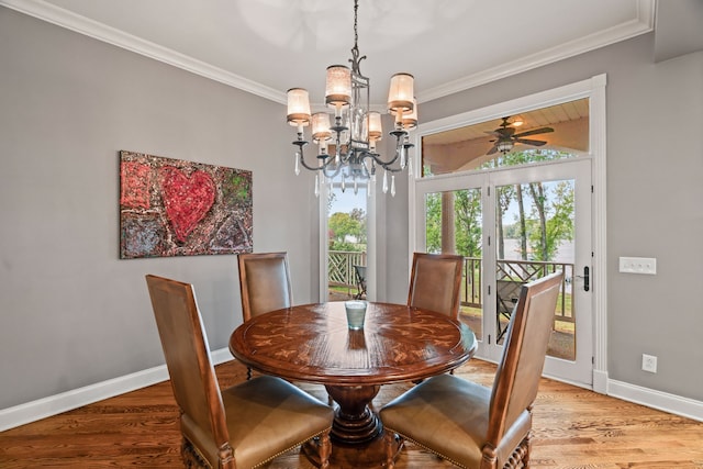 dining room featuring ornamental molding, ceiling fan with notable chandelier, and light hardwood / wood-style floors