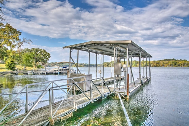 dock area with electric panel and a water view