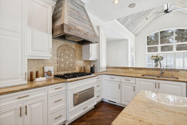 kitchen featuring white cabinets, sink, premium range hood, gas cooktop, and ceiling fan