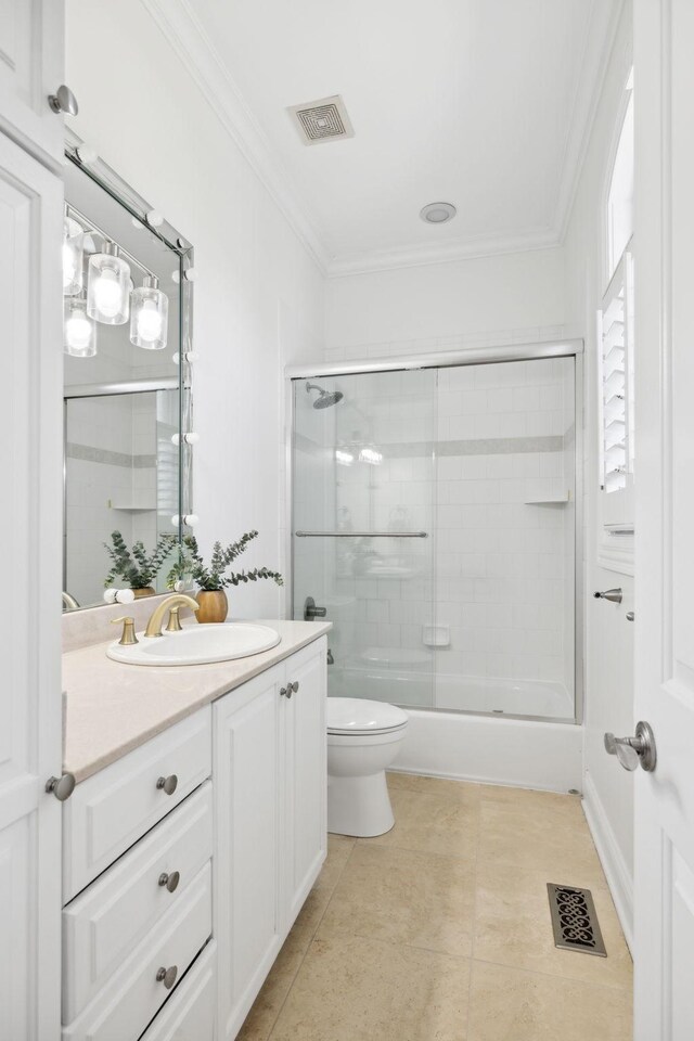 full bathroom with toilet, tile patterned flooring, combined bath / shower with glass door, vanity, and ornamental molding