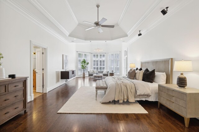 bedroom with crown molding, ceiling fan, dark hardwood / wood-style floors, and a tray ceiling