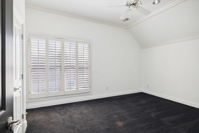 additional living space with lofted ceiling, dark carpet, and ceiling fan