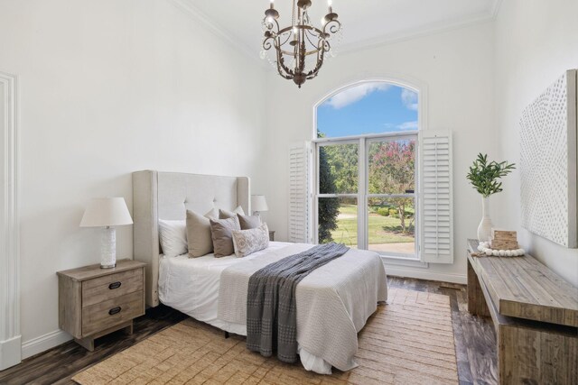 bedroom with hardwood / wood-style floors, a notable chandelier, and crown molding