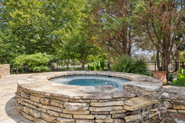 view of swimming pool featuring an in ground hot tub