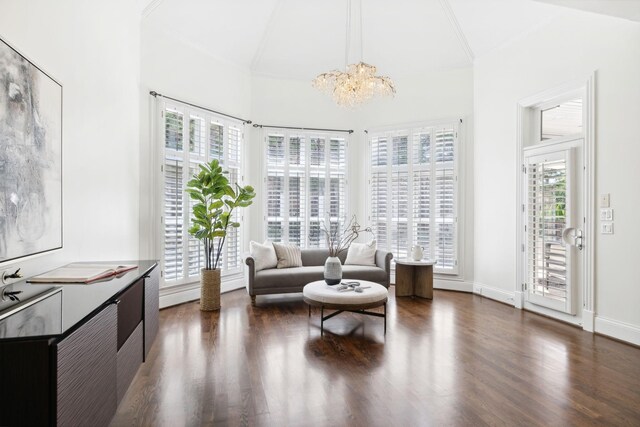 sitting room with dark wood-type flooring, a healthy amount of sunlight, and ornamental molding