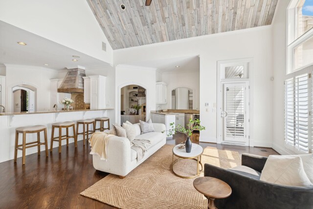 living room with crown molding, plenty of natural light, high vaulted ceiling, and dark wood-type flooring