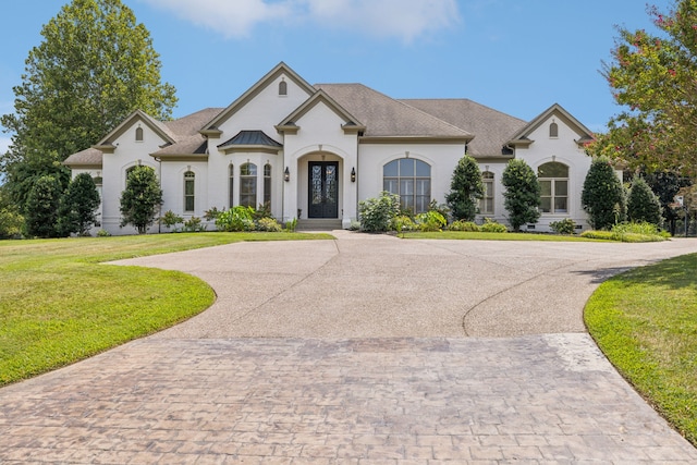 french country home with a front yard