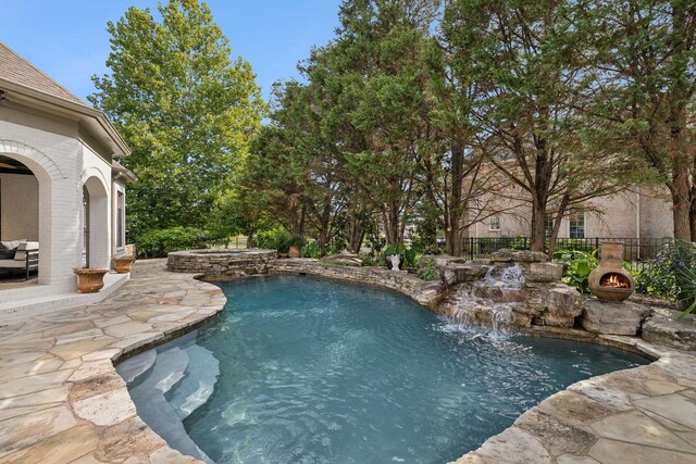 view of pool with pool water feature and a patio area