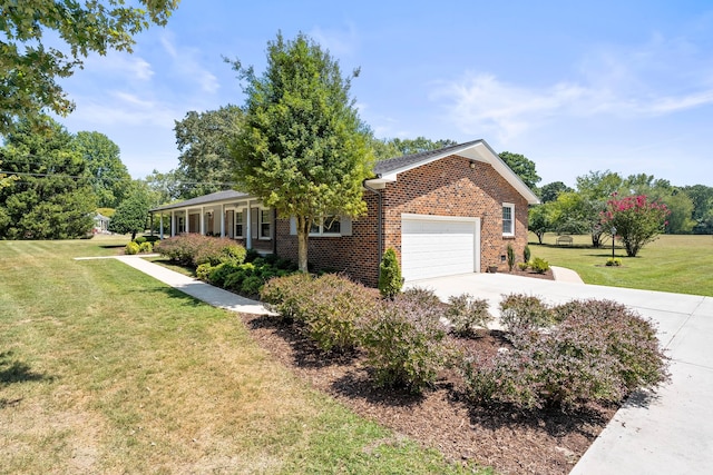 single story home featuring a garage and a front lawn