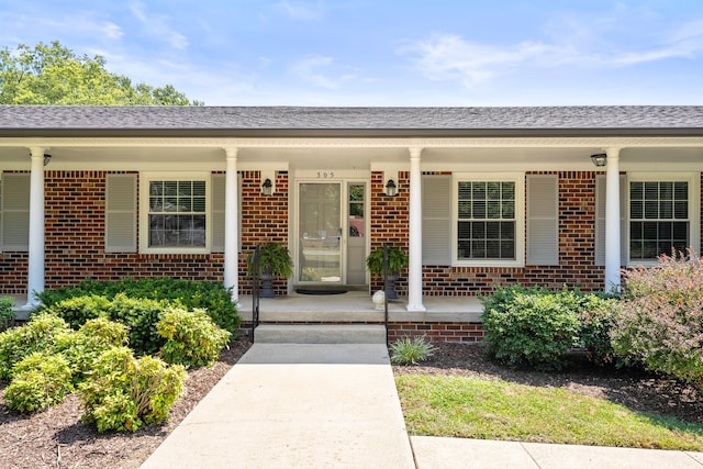 entrance to property featuring covered porch